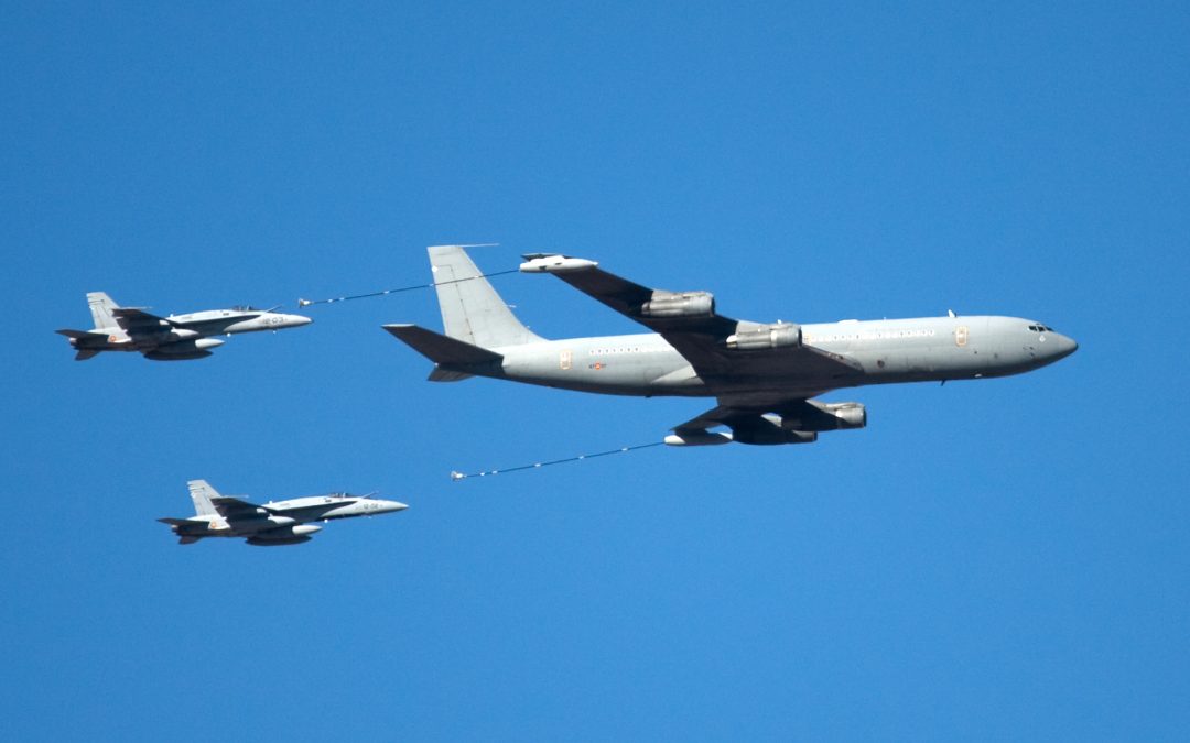 Planes in the air commencing aerial refueling.